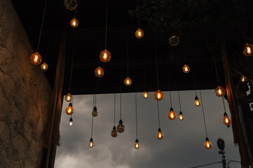 Set of vintage glowing light bulbs on cloudy sky background.Tungstens lights bulbs for inspiration...