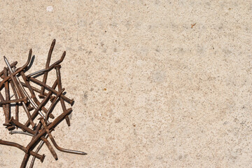 old rusty steel nails on cement background with copy space