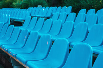 Empty rows of seats in the stadium. Blue and yellow chairs, nobody present at a sport show simple abstract concept