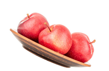 Three red apples on a plate isolated on a white background.