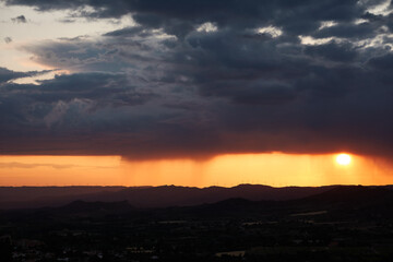 The rain falls on the sunset in the Llaberia Nature Reserve. Tarragona. Catalonia. Spain