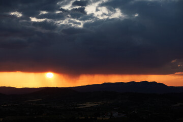 The rain falls on the sunset in the Llaberia Nature Reserve. Tarragona. Catalonia. Spain