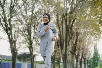 asian woman running and exercising outdoors excitedly