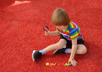 A preschooler plays with the letters of the Hebrew alphabet. The child is learning Hebrew. Ready...
