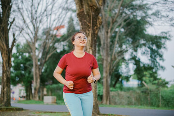 asian woman running and exercising outdoors excitedly