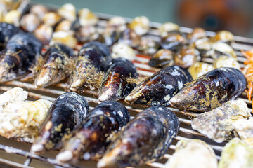 Mixed seafood barbecue on grill metal net