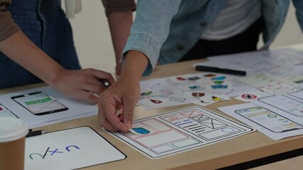 Close up ux developer and ui designer brainstorming interface wireframe design.Creative digital development agency