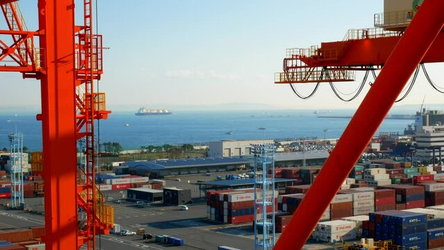 Yokohama, Japan - 01.07.2023 Moss tanks type LNG carrier vessel passing in Tokyo bay and carrying some liquefied natural gas. View from container terminal and some parts of cranes in the video