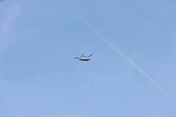 The plane flies in the clear sky.