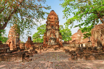 Buddha statue among ruins of the Wat Mahathat in Ayutthaya