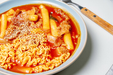 rabokki, Stir-fried Instant Noodle : This dish is tteokbokki with ramen noodles. Tteokbokki is a spicy dish made with rice cake, vegetables, and fish cake, all stir-fried together in a gochujang (red 