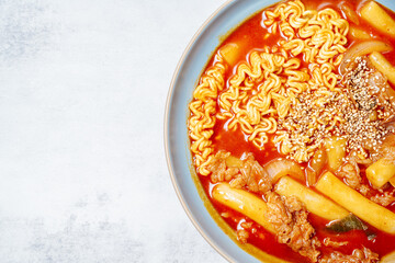 rabokki, Stir-fried Instant Noodle : This dish is tteokbokki with ramen noodles. Tteokbokki is a spicy dish made with rice cake, vegetables, and fish cake, all stir-fried together in a gochujang (red 