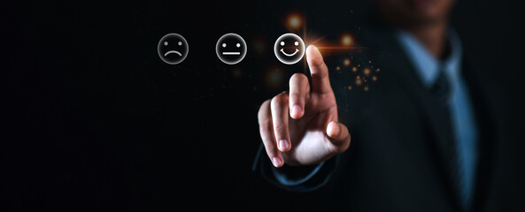 Businessman pressing smiley face emoticon on virtual touch screen. Customer service evaluation...
