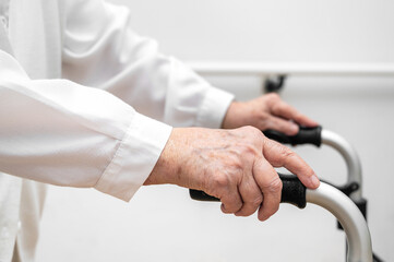Senior patient on folding walker. Recuperation for elderly, seniors care, nursing home. High...