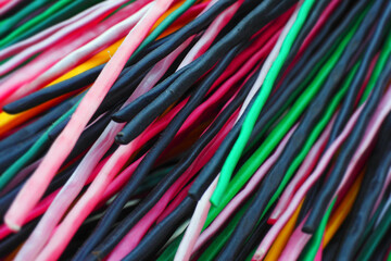 Multi-colored plastic rods for recycling and recyclables. Background in full screen.