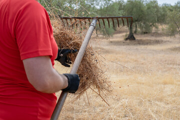 closeup of a rural person cleaning his tool. Bokeh Background.