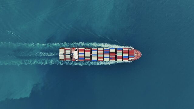 Cargo container Ship, cargo maritime ship with contrail in the ocean ship carrying container and running for export  concept technology freight shipping sea freight by Express Ship. top view 