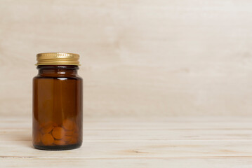 Plastic bottle for vitamins on wooden table