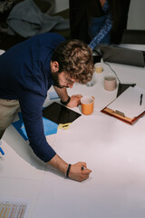Young good looking male person drawing a sketch for starting a new project