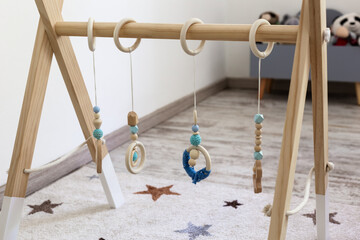 Wooden baby gym. Wooden Montessori mobile holder with baby gym wood toys