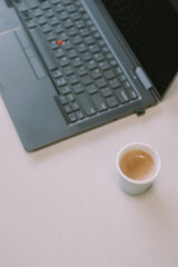Close up of cup of coffee and laptop