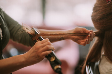 Combing hair at the hair salon. Close up shot