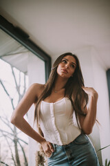 Brunette girl posing at the hair salon after hairdressing 