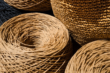 Raffia balls close-up on a wooden board.