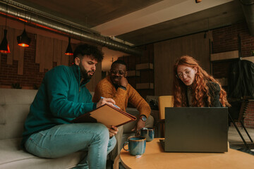 White handsome businessman drawing the new marketing plan for his black male colleague. Their...
