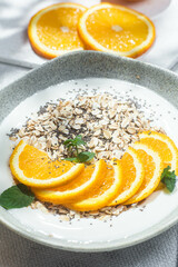 Oatmeal with orange and chia in a bowl .Oatmeal