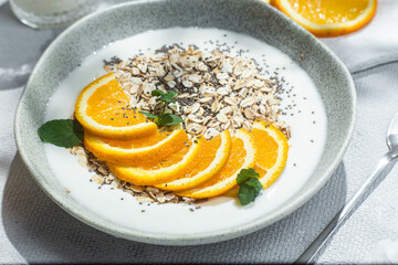 Oatmeal with orange and chia in a bowl .Oatmeal