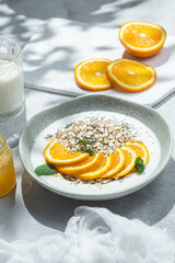 Oatmeal with orange and chia in a bowl .Oatmeal