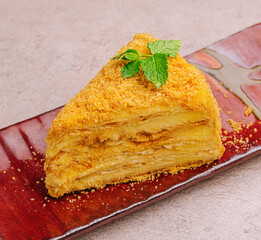 piece of Napoleon Cake on red plate