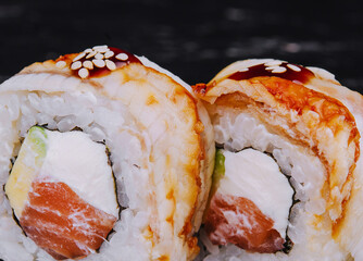 canada roll with salmon on black stone