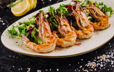 Mixed salad with tiger prawns on plate