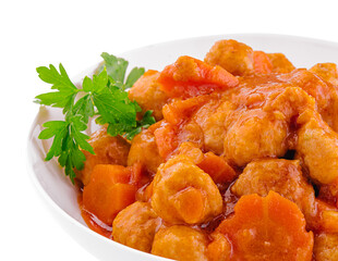 tiftels in carrot sauce in a bowl