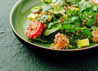 Salad with salmon, couscous, avocado and tomatoes