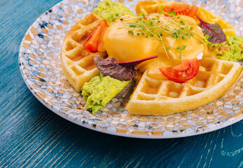belgian waffles with poached egg and avocado