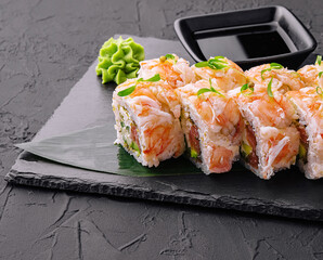 Fresh sushi rolls with shrimp on a stand with soy sauce