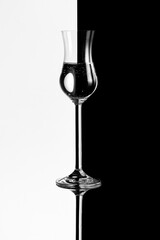 glass of wine on black on a black background
