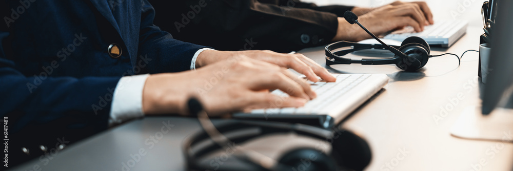 Aufkleber panorama focus headset on call center workspace desk with blur background of operator team or telesa