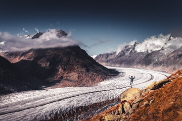 Alpine Aletsch Glacier viewpoint in Valais Canton, Switzerland, Europe. Trekking in Swiss Alps.