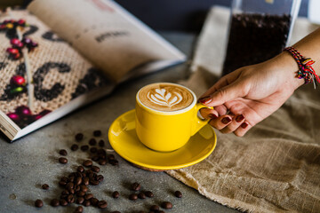 women hand take hot coffee with art