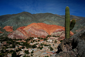 Panoramic view of the town of Purmamarca with Cardon in the foreground. Jujuy, Argentina
