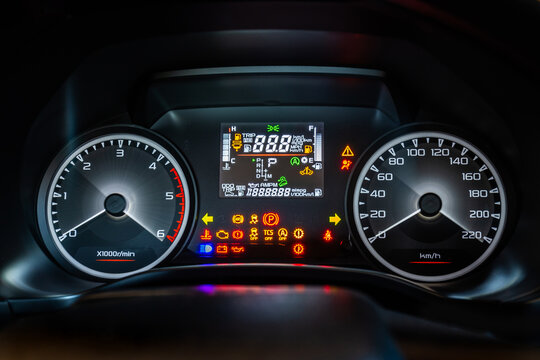 Modern car instrument dashboard panel with digital and analog screen or speedometer and full symbol in night time