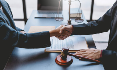 Businessman and lawyer handshake contracting in a mutual agreement, shaking hands to congratulate success.