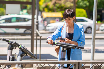 Serious woman scanning QR code on electric scooter
