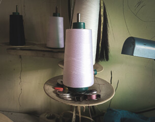 close-up photo of a roll of white sewing thread