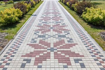 A beautiful path paved with paving slabs in the form of an embroidered Ukrainian ornament.