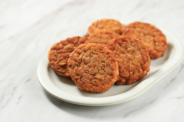 Round Tempeh or Tempe Goreng on White Table